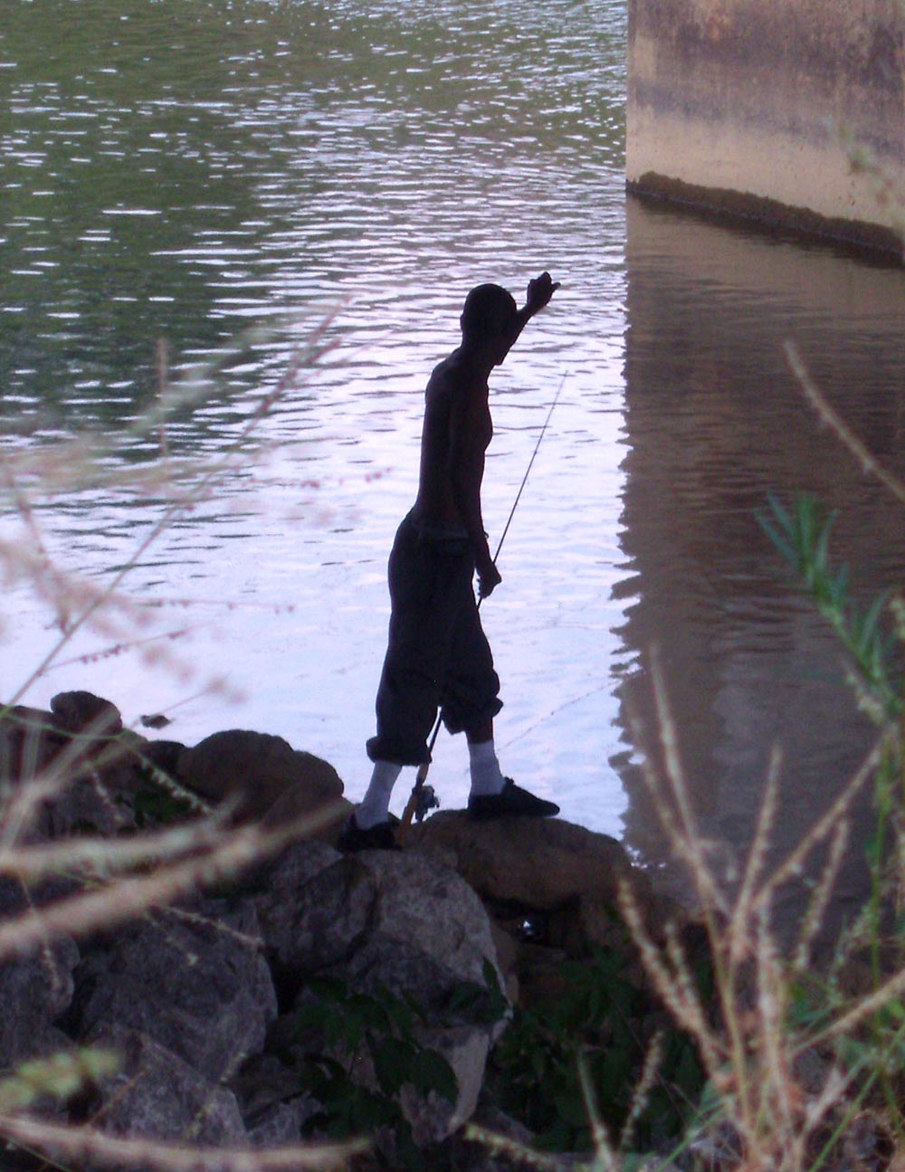 silhouette of someone fishing