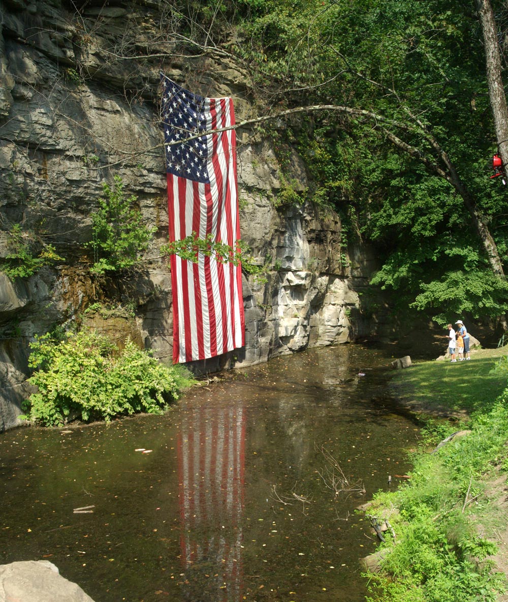 American flag reflected in pond
