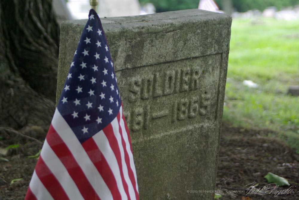 civil-war era headstone with flag