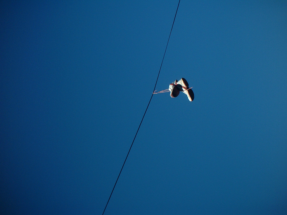 tennis shoes over the telephone line