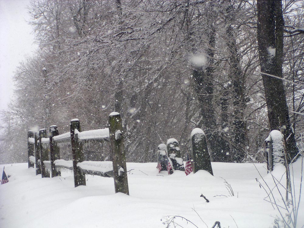 snow falling in old cemetery