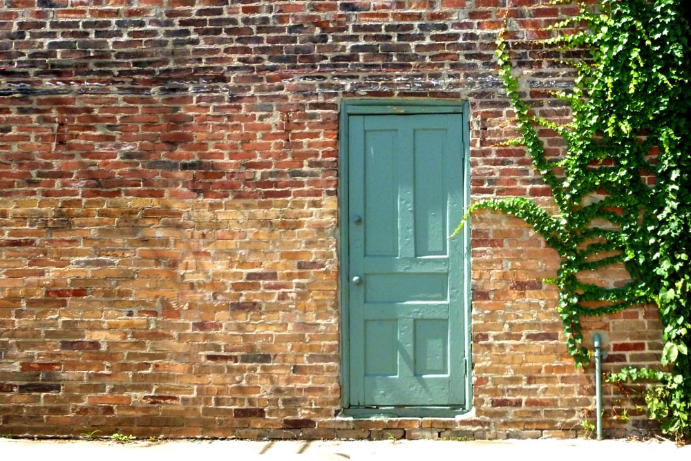 green door in brick wall