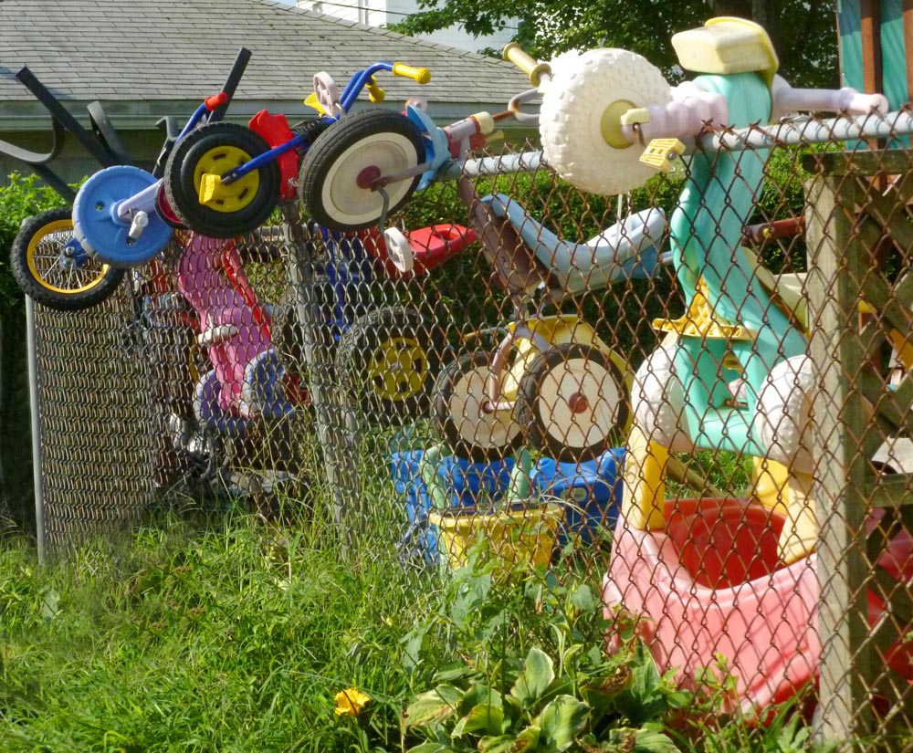 kids toys hanging on fence