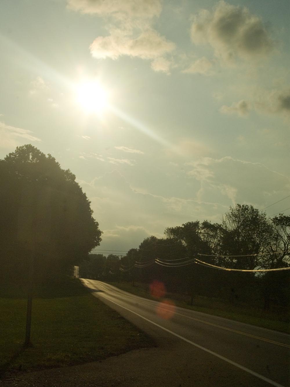 photo of road and sunset