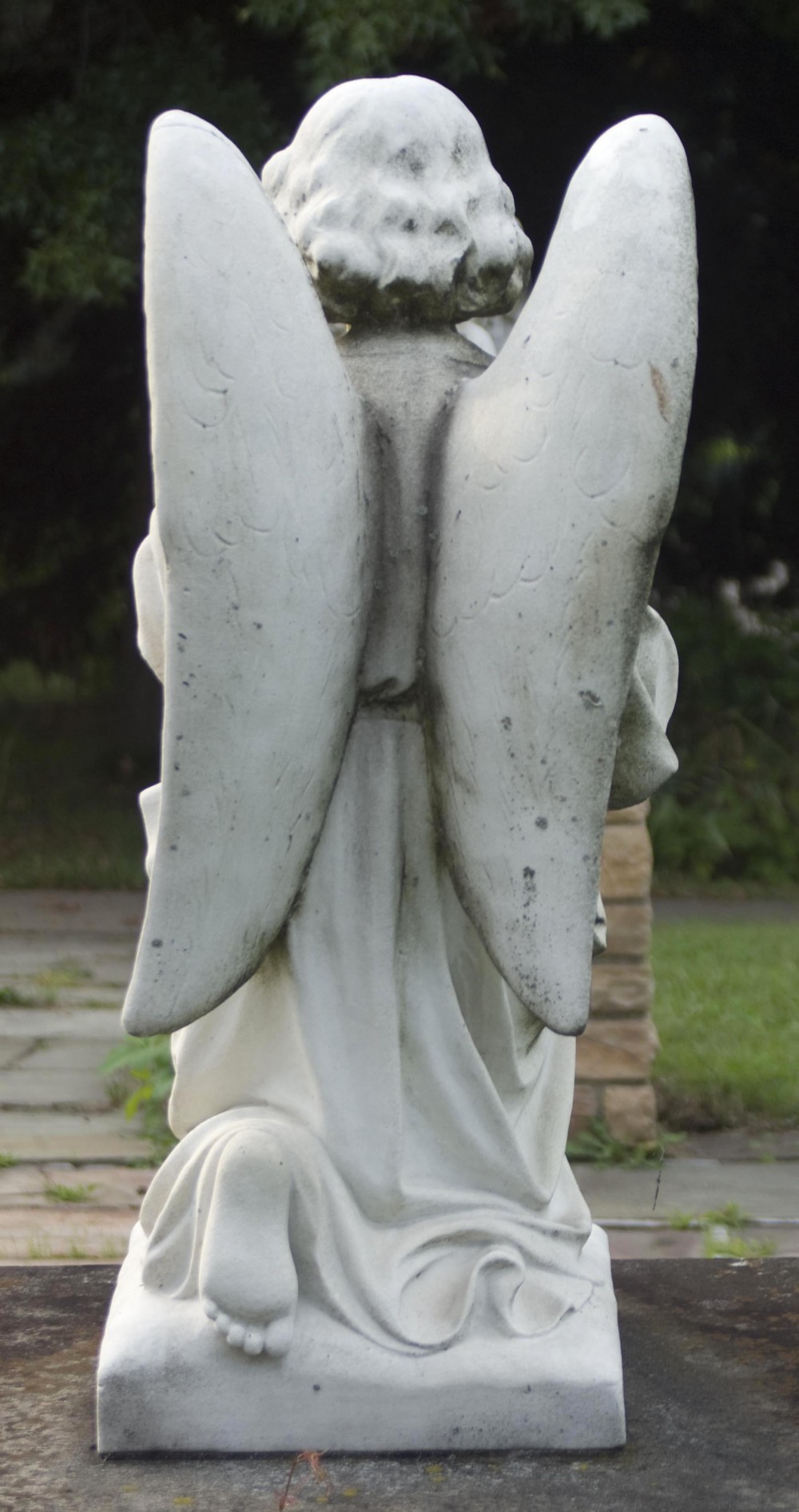 photo of statue of angel from the back