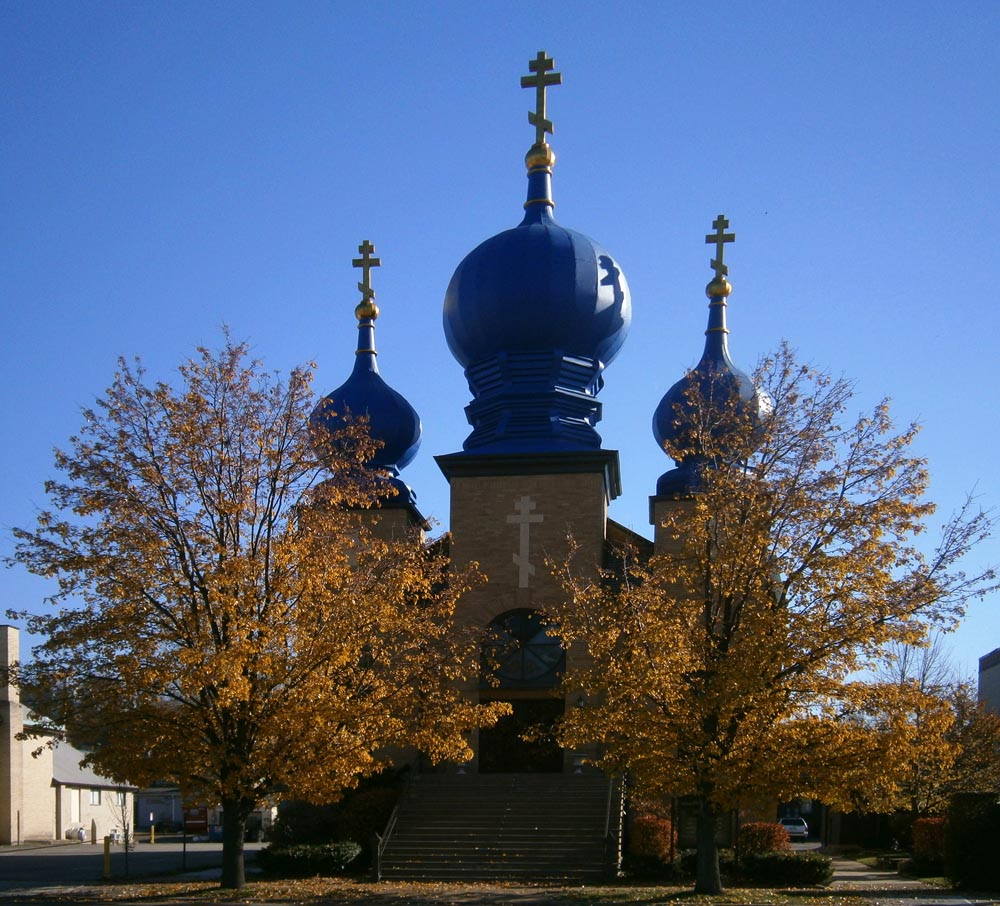 yellow trees in front of church with blue domes