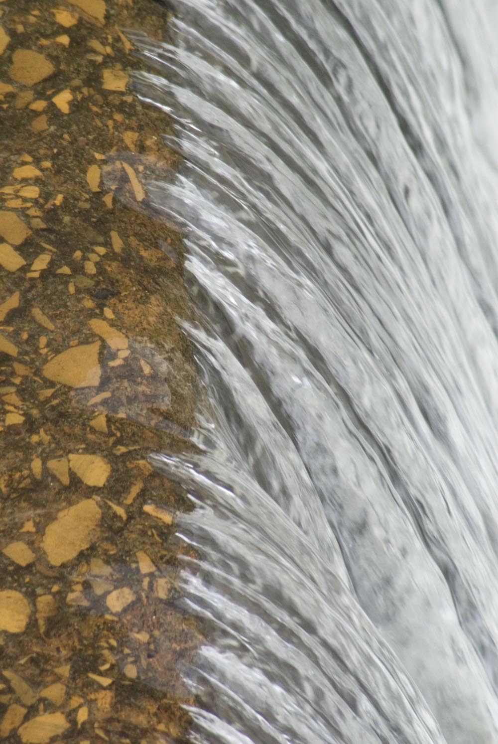 water flowing over dam