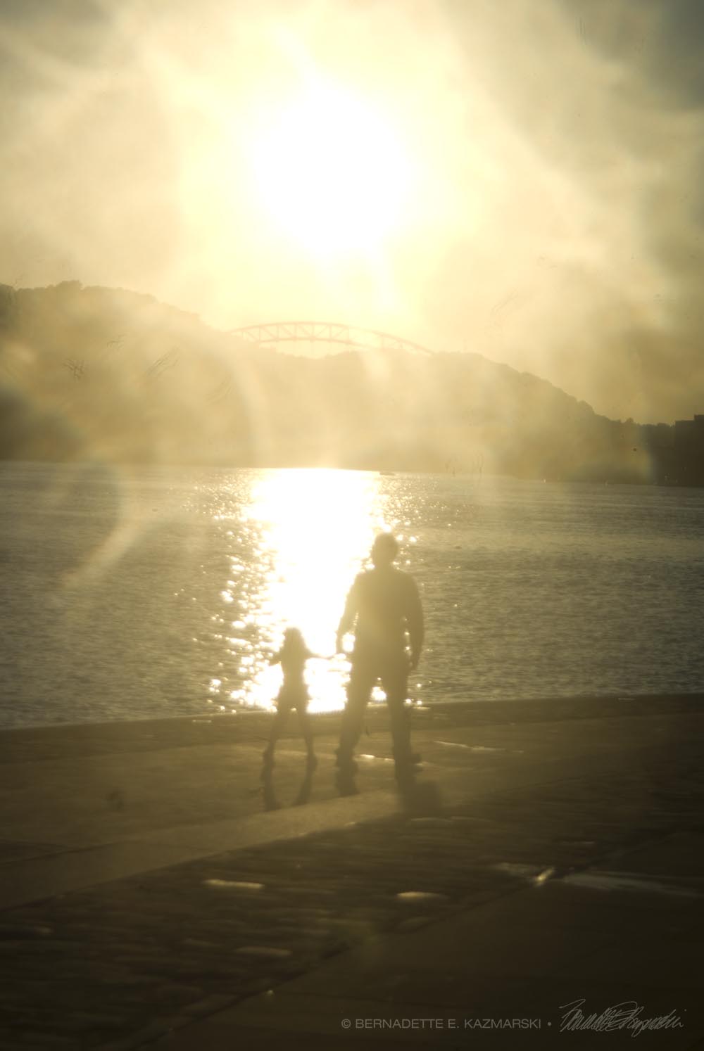 man and child walking by water