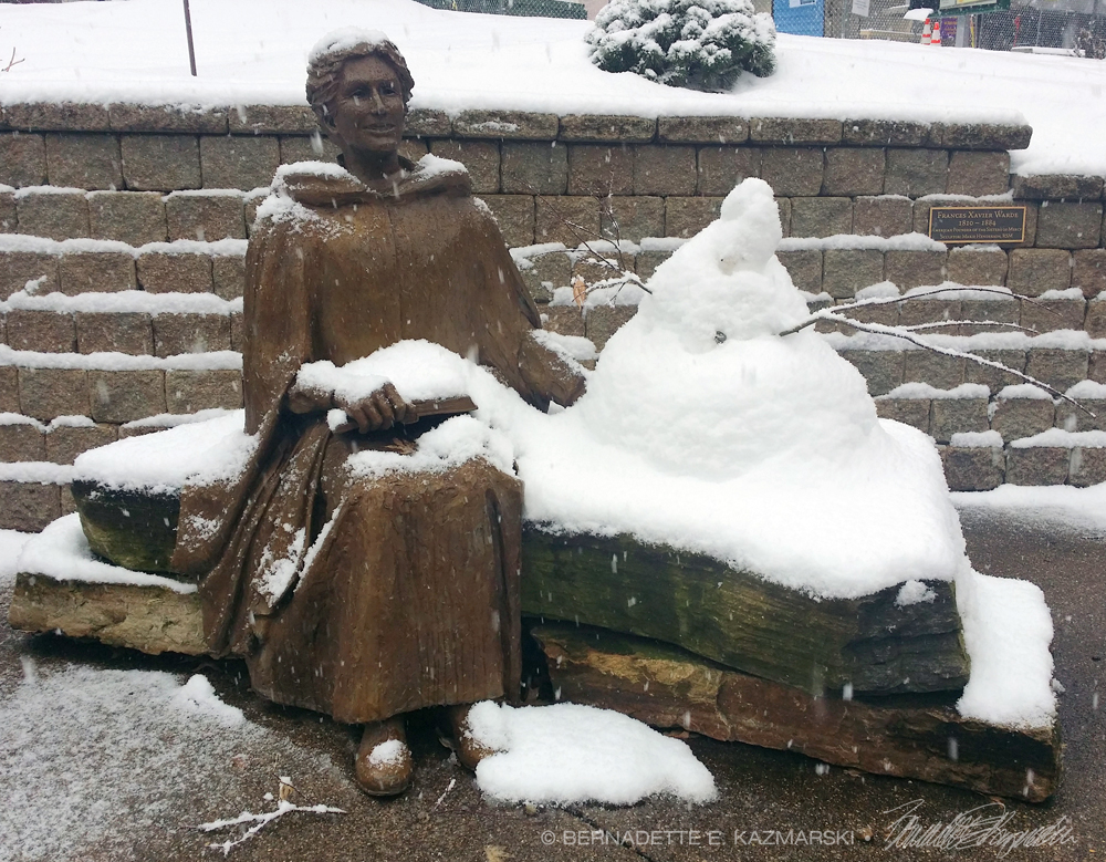 female sculpture and snowman